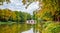 Bridge in the park on the lake. Royal Palace on the Water in Lazienki Park, Warsaw. Lake view in autumn