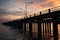 Bridge passing through the frame with lampposts at sunset