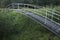 A bridge for pedestrians over a small creek at the forest edge