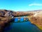 Bridge provides passage over a pristine river running through a lush valley