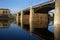 The bridge and the reflection of the bridge in the Volga river, in the morning in the city of Tver.