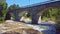 bridge river clear water old viaduct overpass car panning horizontal background