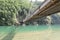 The bridge spanning over the clear and emerald water