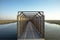 Bridge to bird watching hut on the Markerwadden. Wooden canopy on a jetty that leads to the entrance of a birdwatch view on