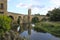 Bridge and a tower over a river and its reflection