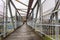 Bridge with a wooden walkway and an aluminium cover