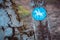 Bridle path round blue sign on a wooden stake, with blurry land path in the background. Germany