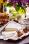 Brie type of cheese. Camembert cheese. Fresh Brie cheese and few slices with whole-grain bun, dry tomatoes, white wine bottle and