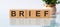 Brief - words from wooden blocks with letters, white background