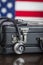 Briefcase and Stethoscope Resting on Table with American Flag Be