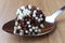 Brigadeiro brigadier, sweet chocolate typical of Brazilian cuisine covered with particles, in a wooden background