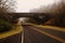 Brige over road through a forest with fog