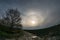 Bright 22 degree halo with upper tangent arc and parhelia over the dutch countryside