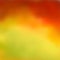 Bright abstract autumn background, beautiful blurred color transition from reds and browns to yellow-green
