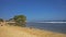 The bright atmosphere of Indrayanti Beach with visitors enjoying the beach