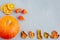 Bright autumn background. Top view on orange pumpkin, autumn leaves, physalis, dried orange slices, flat lay, thanksgiving concept