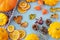 Bright autumn background. Top view of a white and brown checked kitchen towel, orange pumpkin, yellow squash, autumn leaves,