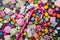 Bright background of sweet multicolored dragee, candies, lollipops, marshmallows