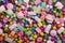 Bright background of sweet multicolored dragee, candies, lollipops, marshmallows