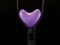 Bright balloon in the shape of a heart, on a black background. Colorful rubber heart in a zipper. Concept: open love, openness