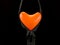 Bright balloon in the shape of a heart, on a black background. Colorful rubber heart in a zipper. Concept: open love, openness