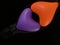 Bright balloon in the shape of a heart, on a black background. Colorful rubber heart in a zipper. Concept: open love, openness