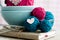 Bright balls of yarn in blue plates and heart made â€‹â€‹of felt