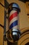 A bright banner for barbershop Montana allows barbers to be labeled and visible. The column consists of a backlit, rotating three-