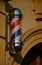 A bright banner for barbershop Montana allows barbers to be labeled and visible. The column consists of a backlit, rotating three-