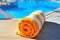 Bright beach towel on the background of the pool
