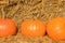 Bright beautiful pumpkins on haystacks. Autumn. Halloween.