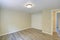 Bright beige empty room with grey hardwood floor