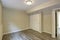 Bright beige empty room with grey hardwood floor