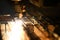 Bright blaze and sparkles while automated laser device cutting steel