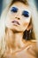Bright blond young woman with fashion style makeup posing sensual