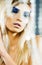 Bright blond young woman with fashion style makeup posing sensual