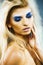 Bright blond young woman with fashion style makeup posing sensual