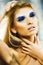Bright blond young woman with fashion style makeup posing sensual