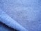 Bright blue cashmere fabric. Texture of warm knitted wool fabric. Natural wool, blue wool fabric.