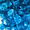 Bright blue crystals made of glass look like gems close-up in the blur. Background from blue stones crystals.