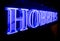 A bright blue HOBBIES neon sign