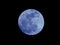 Bright Blue Moon Isolated on a Natural Black Night Sky