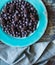 Bright blue plate of blueberries and blackberries ready for eating.