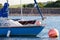 Bright blue sailing boat on a mooring ball