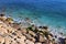 Bright blue sea water and rocky coast