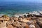 Bright blue sea water and rocky coast