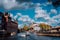 Bright blue sky and fluffy clouds over Amstel in Amsterdam Netherlands, landmark old european city spring autumn landscape