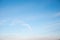 Bright blue sky with light haze clouds and moon