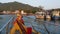 Bright boat with religious amulets floating towards harbor of diving resort on Ko Tao Island in Thailand