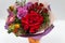 Bright bouquet red, yellow, green, lilac of roses, gerberas, alstroemeria and greenery